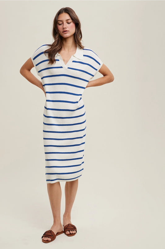 Woman wearing a blue and white striped dress on a beige background