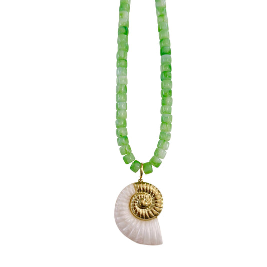 Necklace with green beads and a shell pendant on a white background