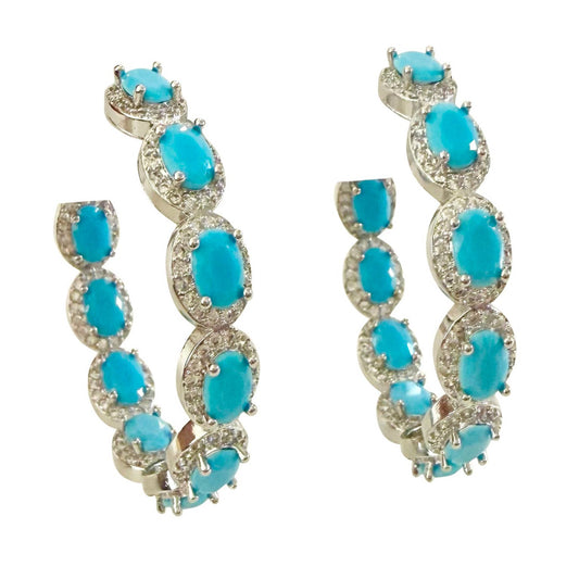 Pair of turquoise hoop earrings on a white background