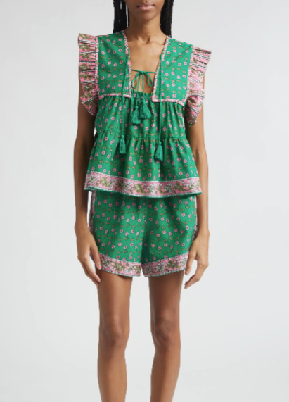 Woman wearing a green patterned outfit on a white background