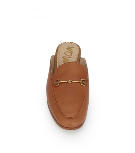 Brown leather slip-on shoe with gold buckle on a white background