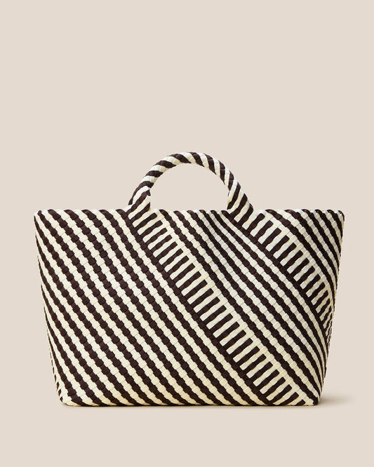 Black and white striped tote bag on a beige background