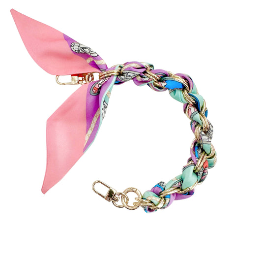 Colorful braided scarf phone chain with a pink bow on a white background